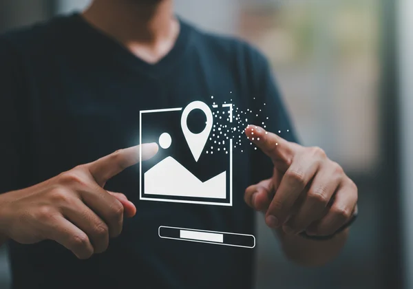 Hand digitally removing location pin from a photo map.